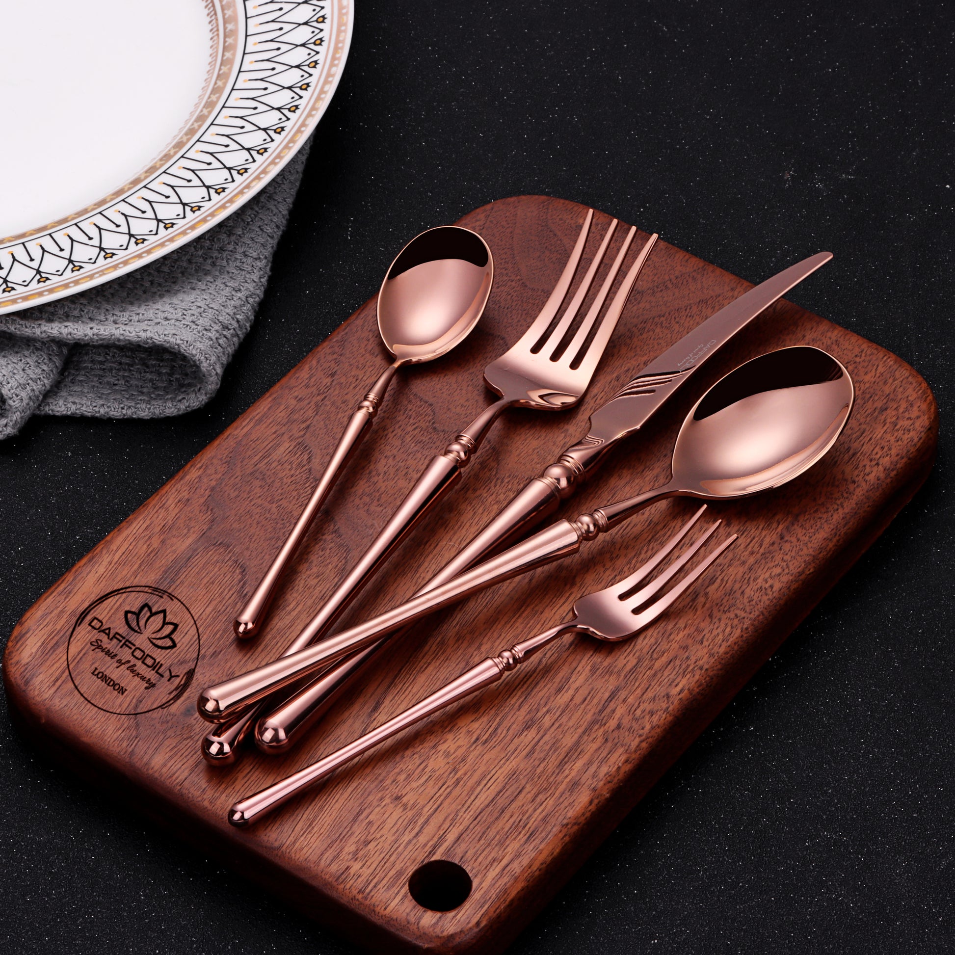 Talin luxury cutlery set in rose gold finish on wooden board