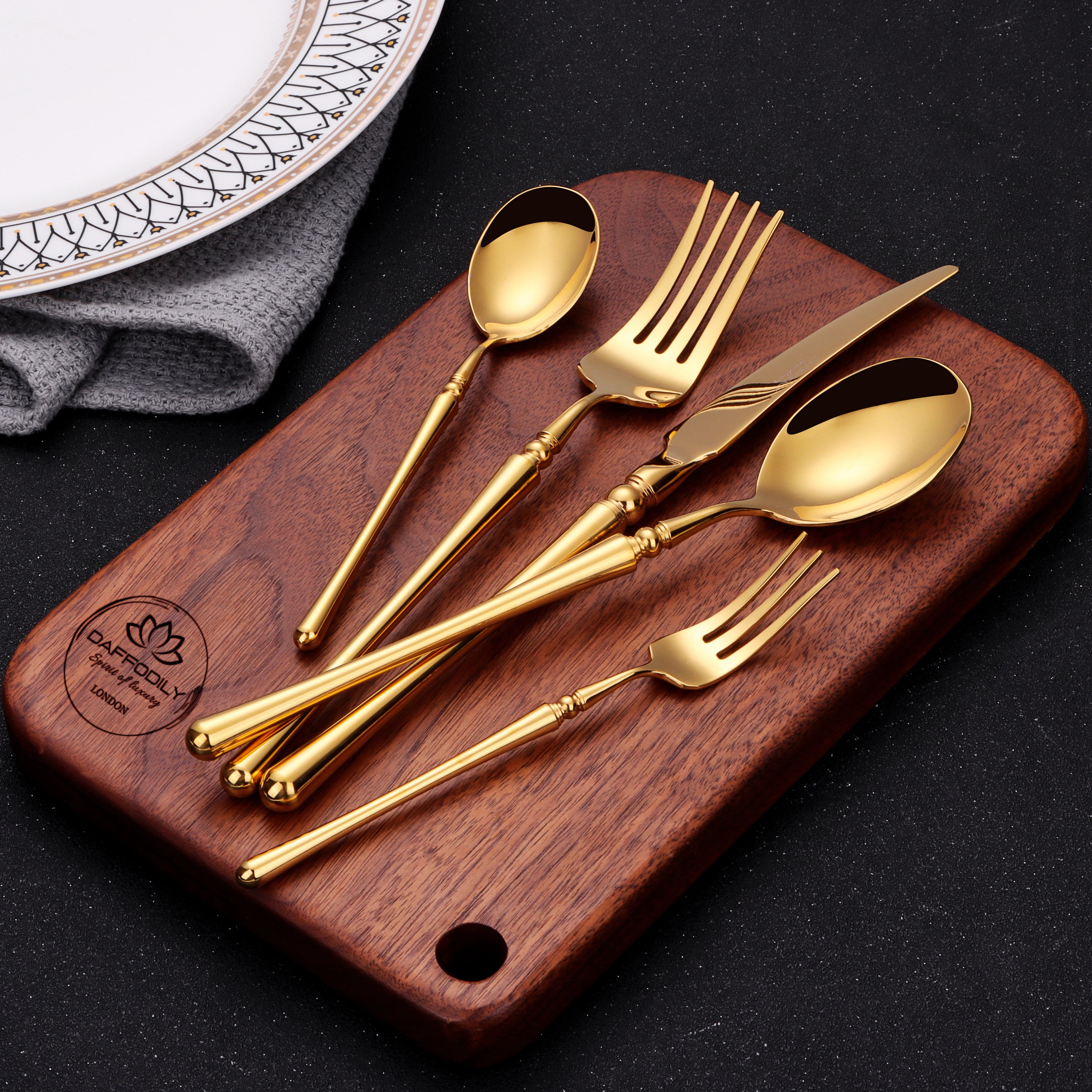 Talin luxury cutlery set with 304 stainless steel and gold finish, modern minimalist flatware on wooden board